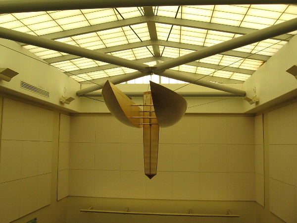 A wood and muslin chandelier is the keel of the abstract catamaran.