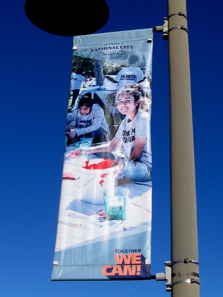 A banner on a street lamp says that in National City, Together We Can!