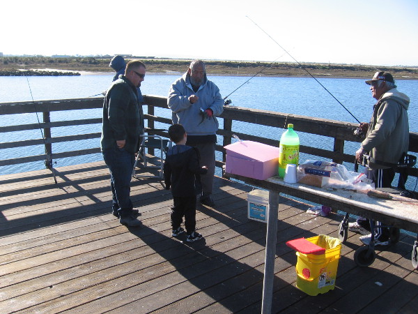 A kid got super excited when these guys caught a mackerel from the pier!