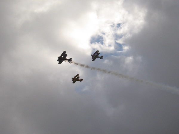 Before the Holiday Bowl Parade began, three cool old biplanes made a fly-by. Trailing smoke is a 1941 Boeing Stearman; the other two are Great Lakes.