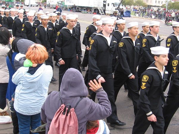 U.S. Naval Sea Cadets march past and receive many waves.