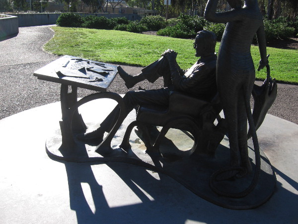 Dr. Seuss relaxes for a bit with a foot up on his work table.