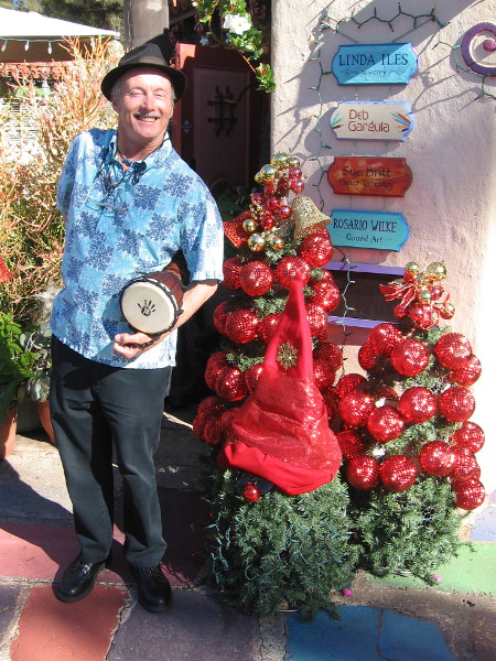 Jeff, the super cool Spanish Village Art Center historian, holds a drum and greets visitors with a huge smile!