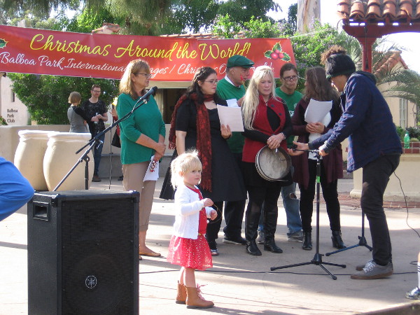 Members of the House of Ireland prepare to sing among the International Cottages during Christmas on the Prado in Balboa Park.