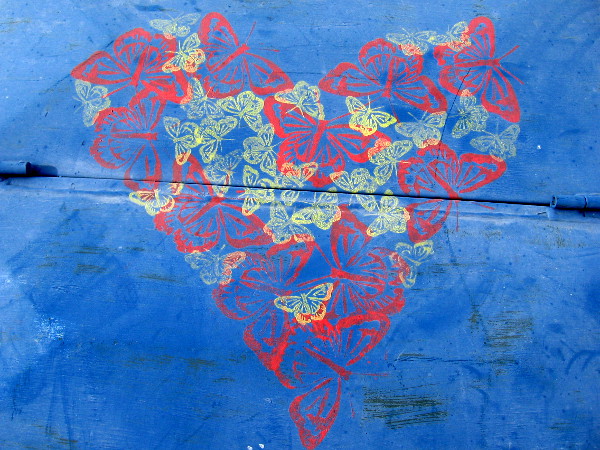 Many colorful butterflies seem to have landed atop an electrical box in Golden Hill, forming a heart.