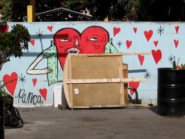 A fun heart in a mural on a neighborhood wall.
