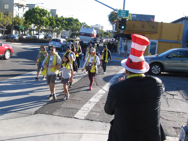 Those who will participate in the historic Book Pass, wearing yellow scarves, fan out along seven blocks of West Washington Street in Mission Hills.