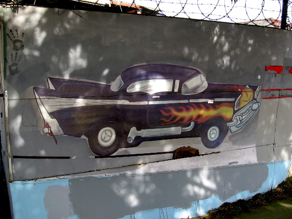 A cool car painted on a fence along Commercial Street in Logan Heights.