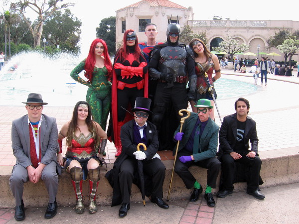 The JLA poses in Balboa Park. Members of San Diego's Science Fiction Coalition enjoy cosplay as Mera, Batwoman, Superman, Batman, Wonder Woman, Clark Kent, another Wonder Woman, Penguin, Riddler and Superboy!