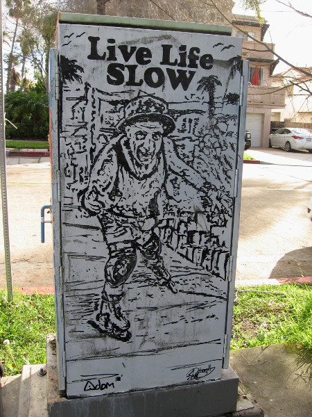 A guy inline skates down the Pacific Beach boardwalk. Live Life SLOW.