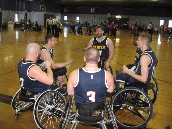 Athletes in the National Wheelchair Basketball Association gather during a time out during the Third Annual Brad Rich Invitational at Balboa Municipal Gymnasium.