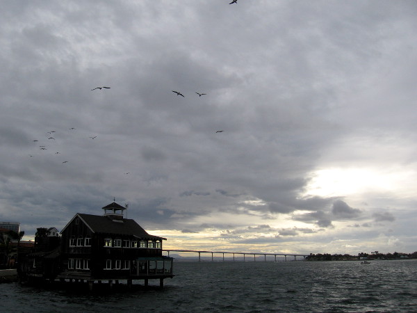 Some light in the distance beyond the Coronado Bay Bridge as clouds deepen.