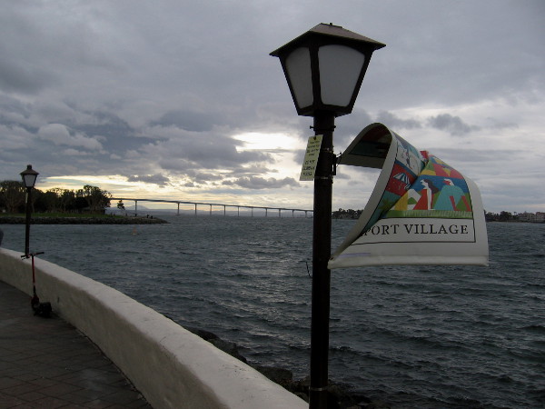 A Seaport Village banner twists in a gust.