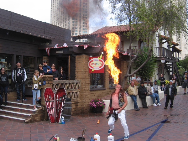 San Diego's own world-famous Murrugun the Mystic exhales a huge fireball during Seaport Village's 2019 Busker Fest!