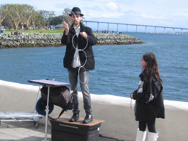 Back near the water, Jonathan Strange was doing ring linking magic with an assistant from the audience.