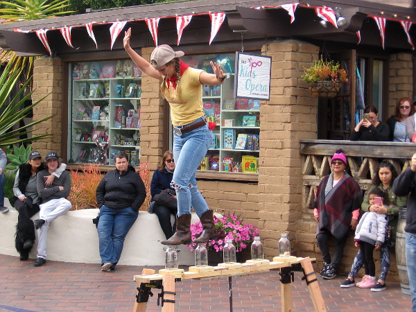 The Farmer's Daughter keeps balance as she walks along the top of glass milk bottles--with one good eye! A wildly successful show, in spite of her contact lens difficulty!