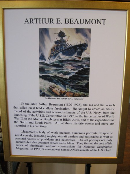 Sign describes the life and work of Arthur E. Beaumont, named by the Navy the Artist Laureate of the U.S. Fleet in 1958. He is also known for his wartime commissions for National Geographic Magazine.
