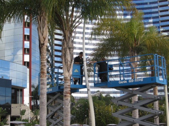 Workers string some lights near the Marina Terrace.
