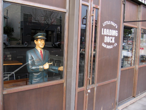 A friendly attendant stands by in a window of Little Italy's Loading Dock.