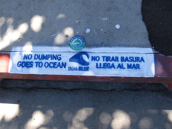 Newly stenciled message by a storm drain in Point Loma. NO DUMPING GOES TO OCEAN