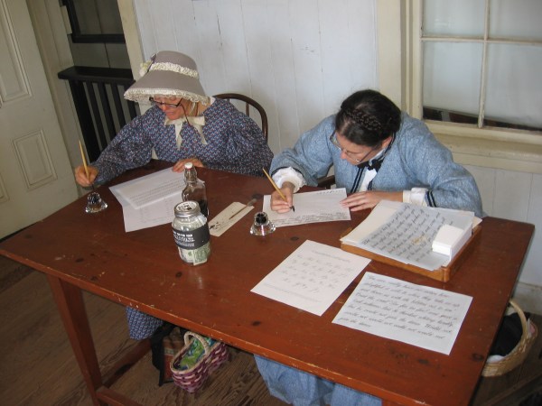 In the entrance of the San Diego Union Building, ladies sat at a desk practicing their penmanship.