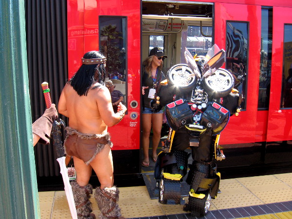 Bumblebee and barbarian friend boarding a trolley in San Diego