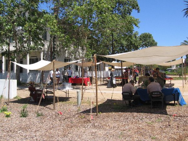 A row of tents near the McCoy House Museum welcomes curious visitors during the Earth Day Open House event.