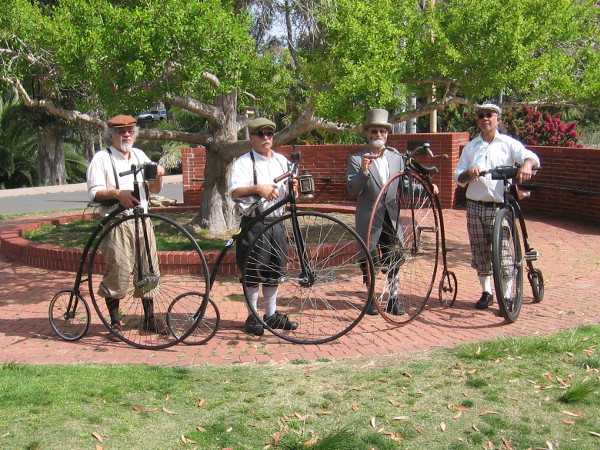 Four gentlemen and their high wheels.