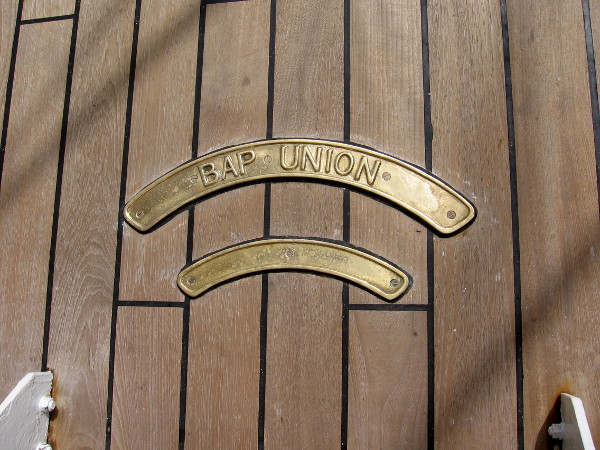 Shining plaques in the wooden deck at the foot of some steps.