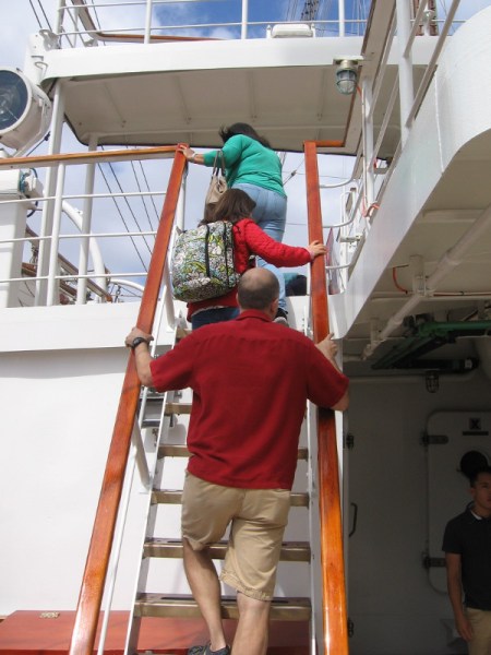 Climbing up the steps that lead to an area near the ship's bridge.