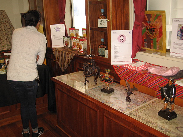 Inside a comfortable cabin, visitors enjoy looking at many cultural displays concerning Peru, including exquisite crafts and textiles.