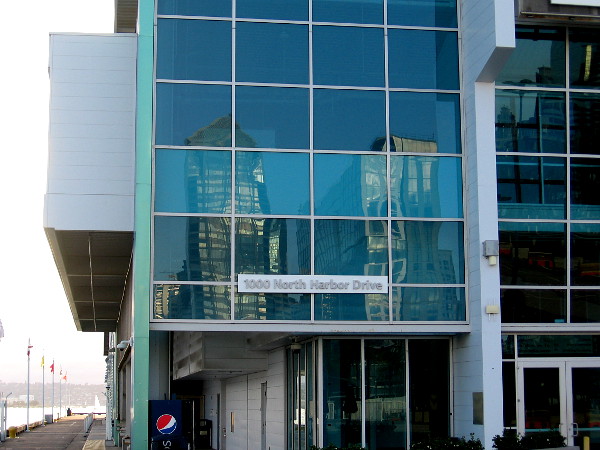 The reflections of downtown skyscrapers shine in the Port Pavilion's windows, a few minutes before sunset.