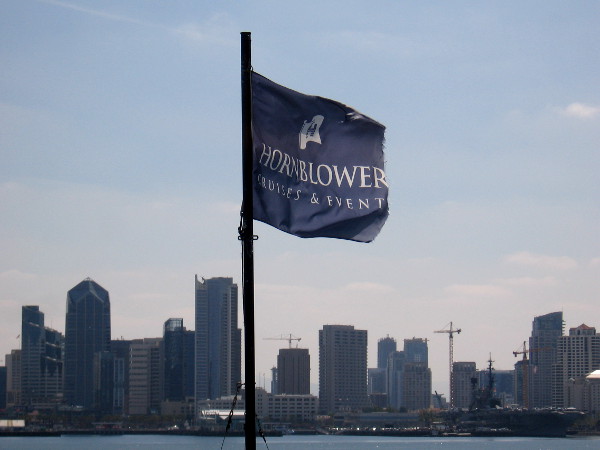 The billowing Hornblower flag and the approaching San Diego skyline.