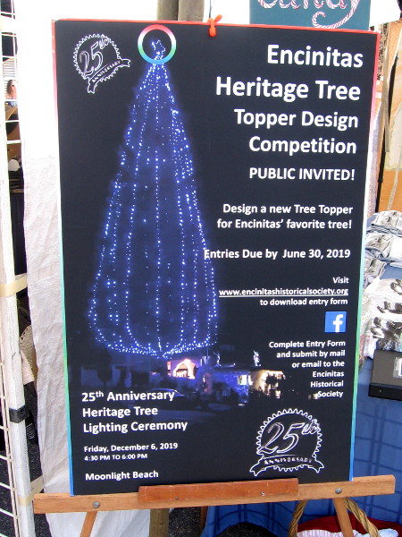 A poster details The 25th Annual Encinitas Heritage Tree Contest! The heritage tree was planted in 1952 above Moonlight Beach.