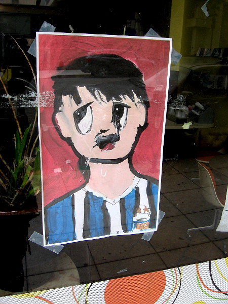 An exhausted face looks out from the window of Via Pia restaurant.