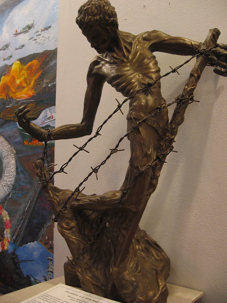 A nearby bronze sculpture by Don Schloat, made from his personal experience in World War II. Palawan: U.S. POW Martyr.