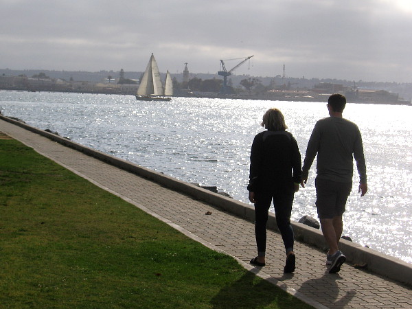 A couple walks along Embarcadero Marina Park North.
