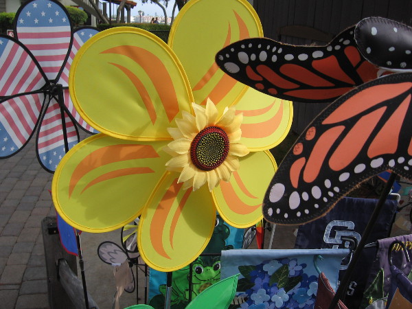 A spinning yellow sunflower at Alamo Flags in Seaport Village.