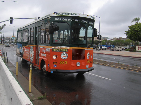 Some tourists take a look at San Diego Bay from the dry comfort of an Old Town Trolley.