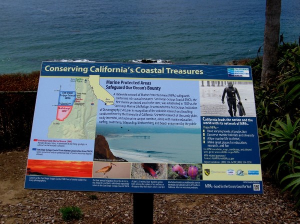 Conserving California's Coastal Treasures. Sign describes Marine Protected Areas. Just offshore is the San Diego-Scripps Coastal SMCA.
