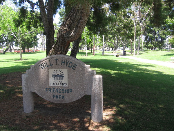 Green grass and shady trees fill the Will T. Hyde Friendship Park, north of the Chula Vista Library.