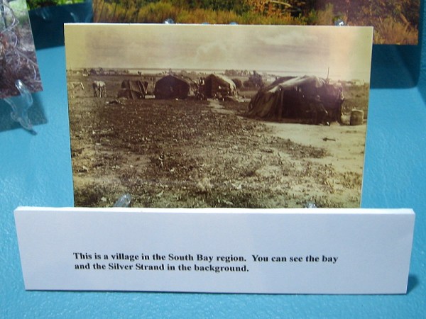 Historical photo of a Kumeyaay village in the South Bay region. San Diego Bay and the Silver Strand are visible in the background.
