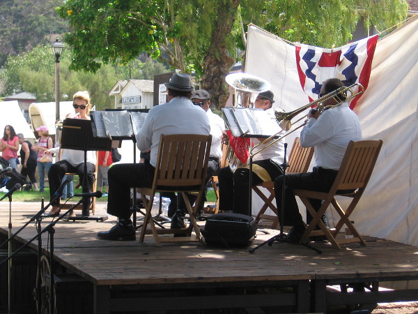 The Westwind Brass Ensemble plays on stage in Old Town San Diego's plaza during an 1800's Fourth of July.