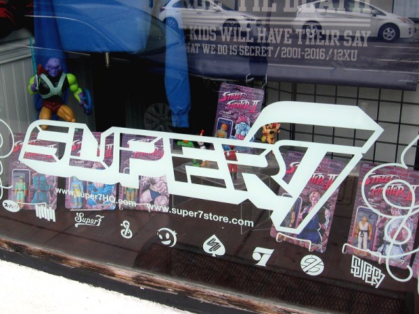 The window of the Super7 pop-up location is packed full of cool figurines.