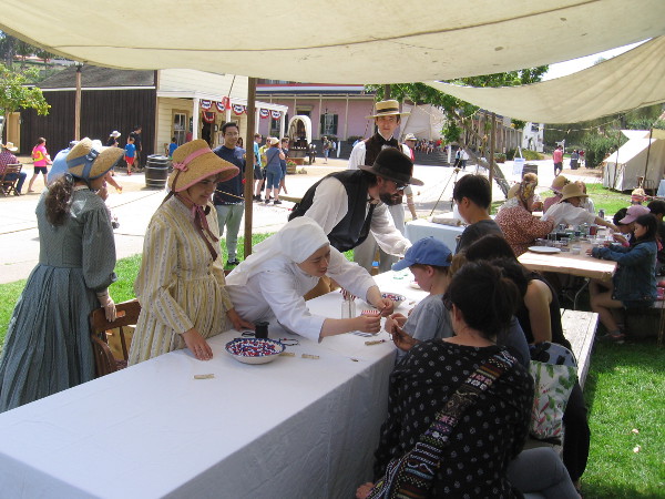 These kids were making stuff with beads.