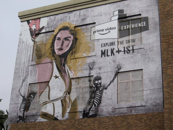 A building wrap near the Gaslamp Quarter sign promotes Amazon Prime's original series and their nearby offsite during 2019 Comic-Con.