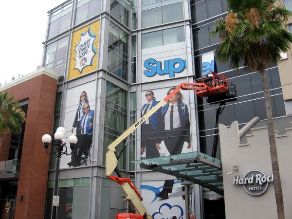 A wrap on the building's south side shows characters from Superstore.