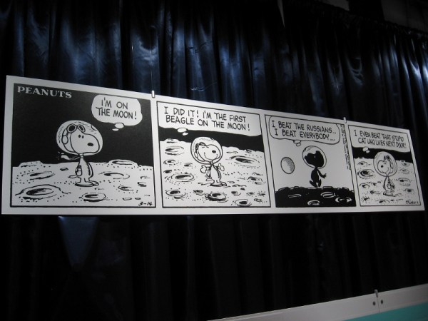 The second of two Peanuts comic strips on display. Snoopy beat the neighbor's cat to the moon.