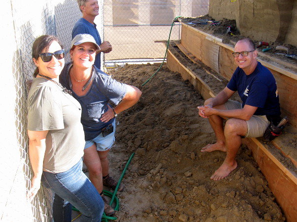 Cool sand artists rest for a bit near the foot of Broadway Pier as they create a welcoming sculpture for the 2019 U.S. Sand Sculpting Challenge! A couple faces look familiar from past competitions!