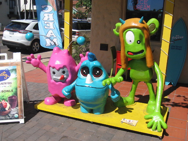 Three happy, silly creatures greet fun-loving people in front of Dr. Freeze Amazing Desserts!